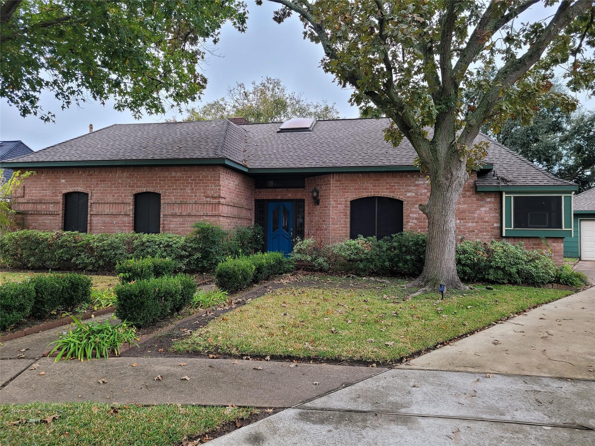 14834 La Rana Drive Houston, TX 77083 - Photo 2 of 14 Features a sun-brightening skylight, professional landscaping, and a spacious driveway leading to a detached garage.