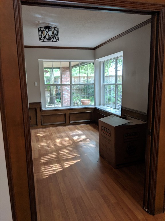 14834 La Rana Drive Houston, TX 77083 - Photo 5 of 14 Bright room with wood floors, large windows, and modern lighting—ideal for dining or sitting.
