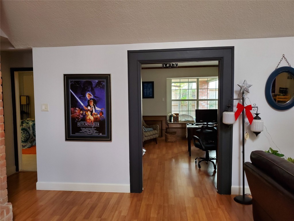 14834 La Rana Drive Houston, TX 77083 - Photo 6 of 14 Cozy interior with wood floors, doorway to bright room, and stylish décor accents.