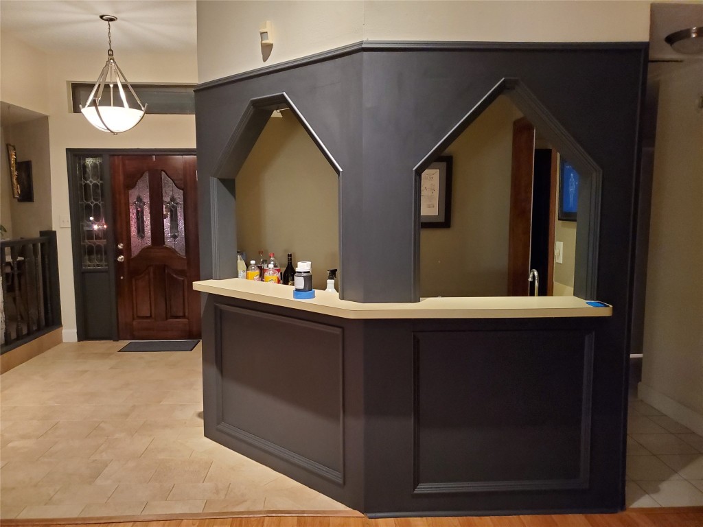 14834 La Rana Drive Houston, TX 77083 - Photo 8 of 14 Entryway with decorative glass door, tiled floors, and modern lighting—includes stylish bar area for entertaining.