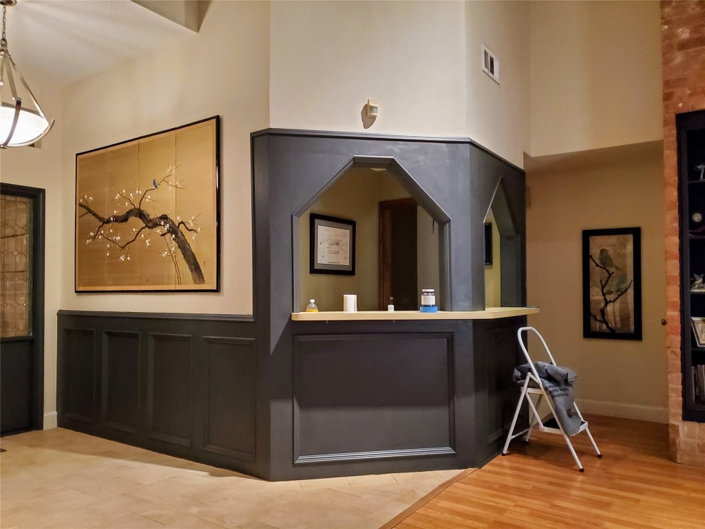 14834 La Rana Drive Houston, TX 77083 - Photo 9 of 14 Cozy corner with dark wood paneling, small bar, and warm lighting.