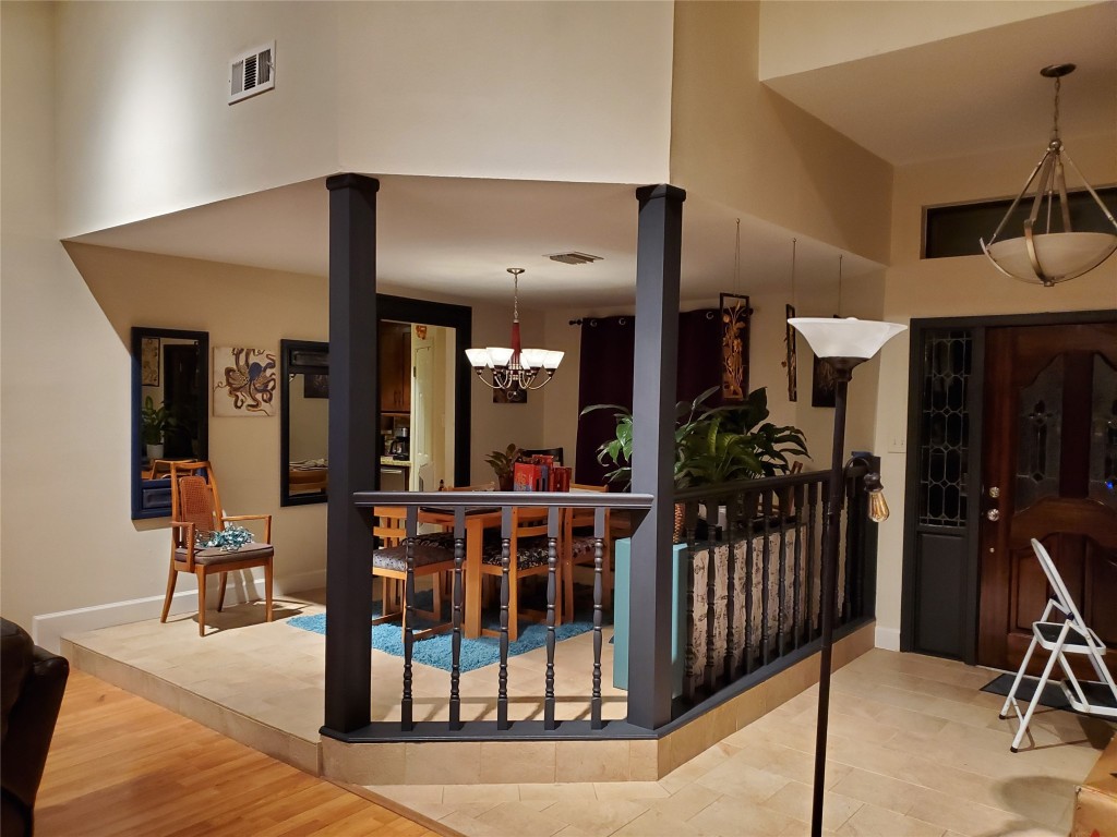 14834 La Rana Drive Houston, TX 77083 - Photo 10 of 14 Raised dining area with elegant lighting, wood accents, and warm tones.