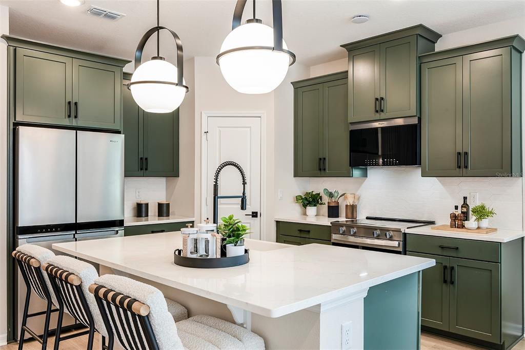 663 Clark Street Oviedo, FL 32765 - Photo 2 of 9 a kitchen with stainless steel appliances granite countertop a sink and a refrigerator