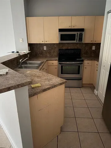 a view of wooden floor and windows in a room
