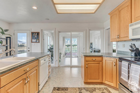 19 East Southfield Road Spanish Fork, UT 84660 - Photo 56 of 74 Kitchen with a peninsula, plenty of natural light, white appliances, recessed lighting, and light brown cabinetry