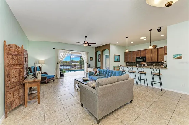 a living room with furniture and kitchen view
