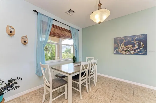 a kitchen with a stove a sink a kitchen island with chairs and wooden cabinets
