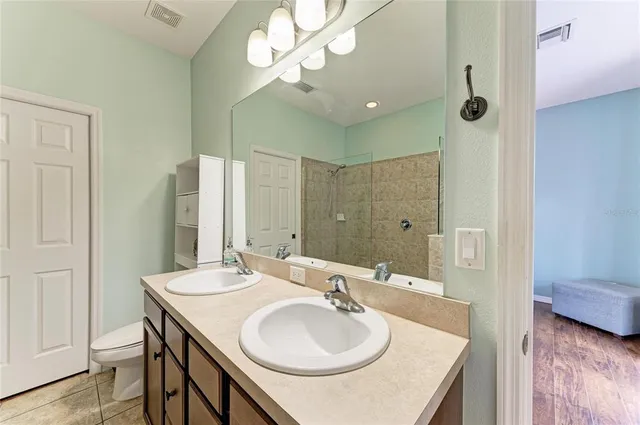 a bedroom with furniture and large windows