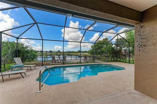 an aerial view of residential houses with outdoor space and river