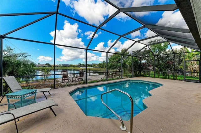 an aerial view of a house with swimming pool yard and outdoor seating