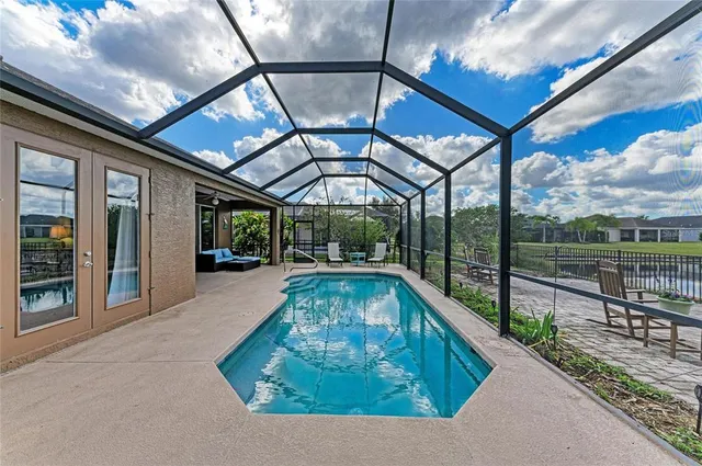 an aerial view of a house with yard swimming pool and outdoor seating