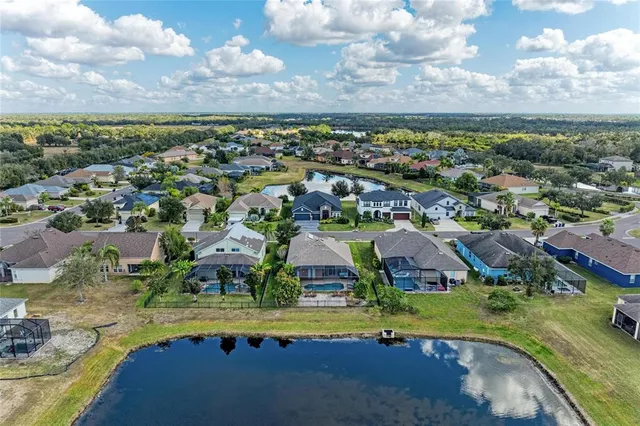an aerial view of residential houses with outdoor space and city view