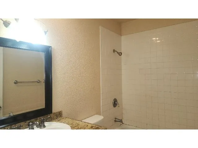 a open kitchen with windows and ceiling fan