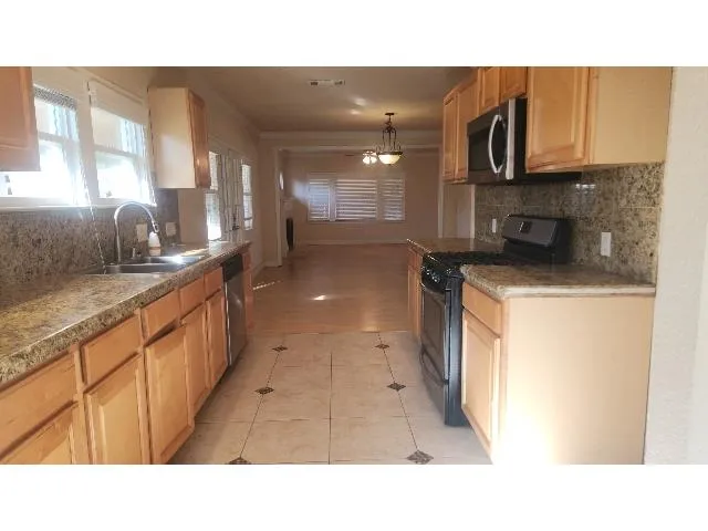 a open kitchen with sink and cabinets