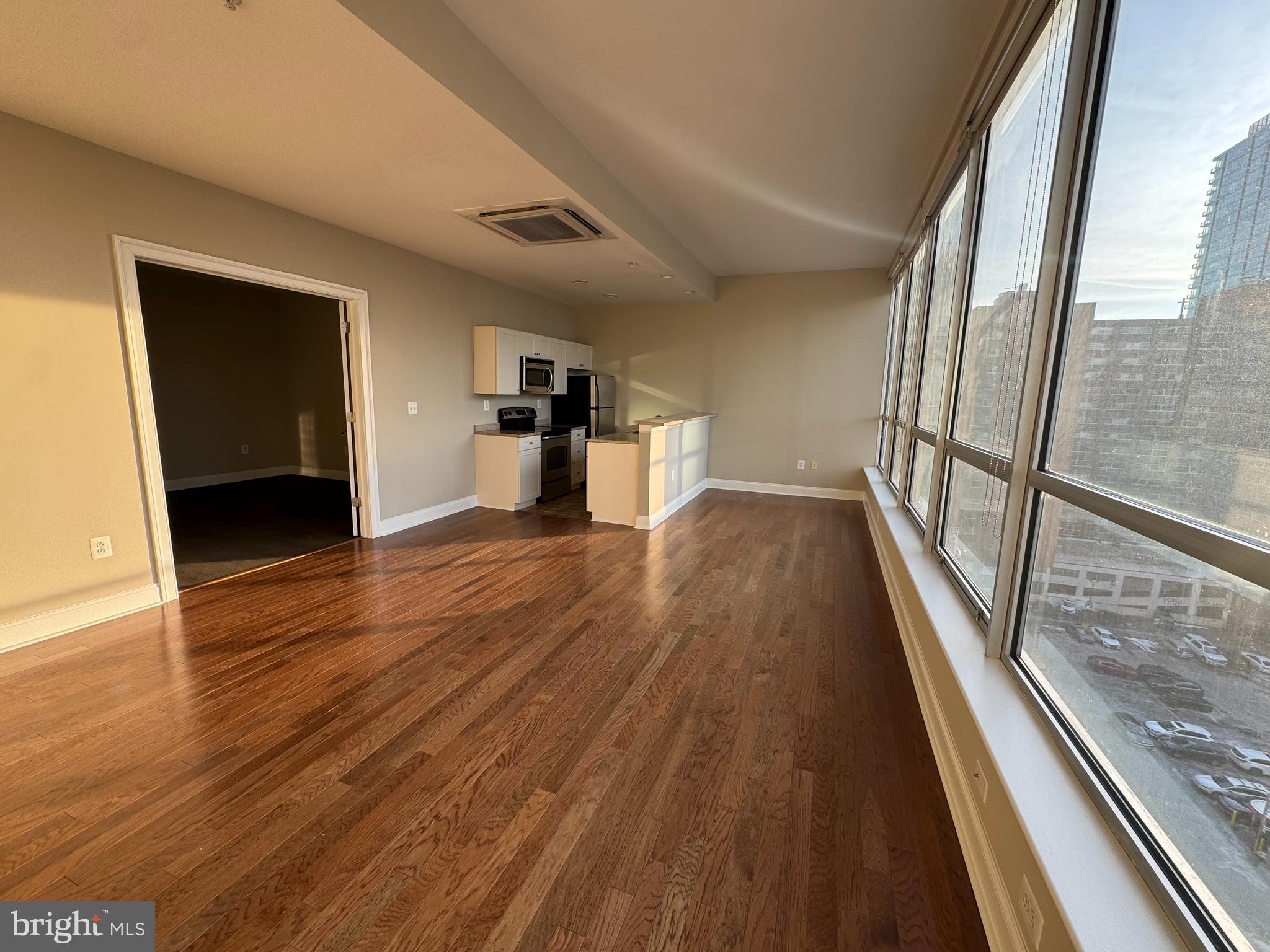 2040 Market Street, Unit 312 Philadelphia, PA 19103 - Photo 3 of 12 wooden floor in an empty room with a window