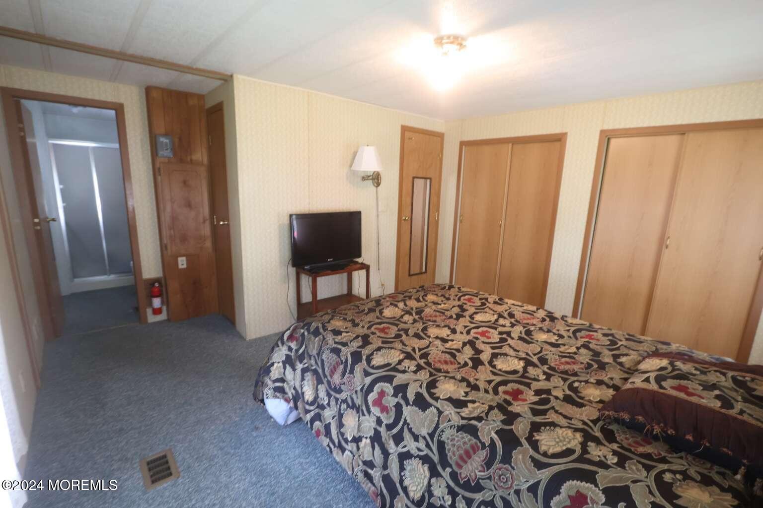 78 Eagle Drive Whiting, NJ 08759 - Photo 16 of 24 a bedroom with a bed and a flat tv screen on dresser