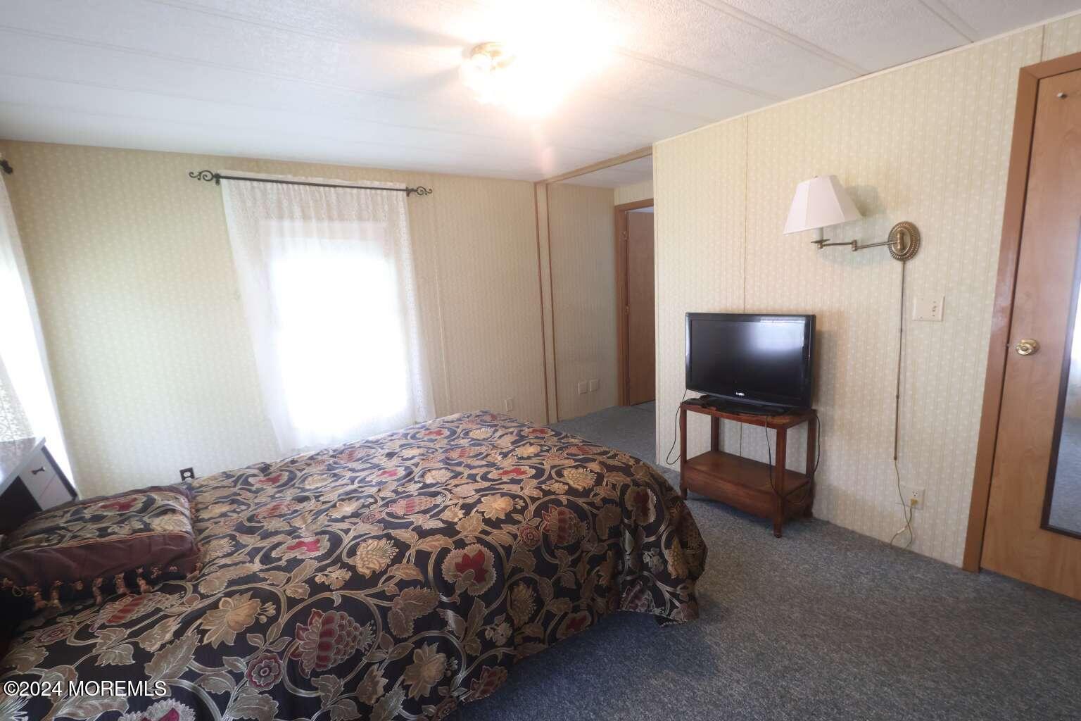 78 Eagle Drive Whiting, NJ 08759 - Photo 18 of 24 a bedroom with a bed and a flat screen tv