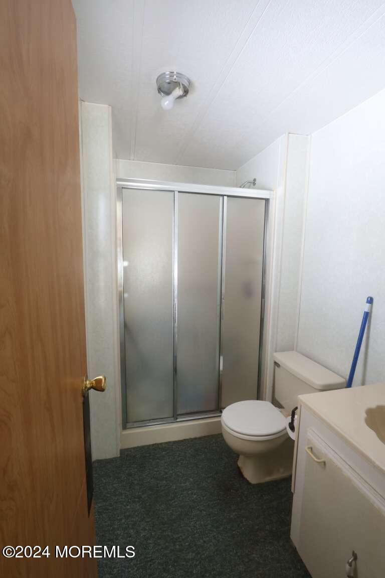 78 Eagle Drive Whiting, NJ 08759 - Photo 23 of 24 a bathroom with a granite countertop toilet and a shower
