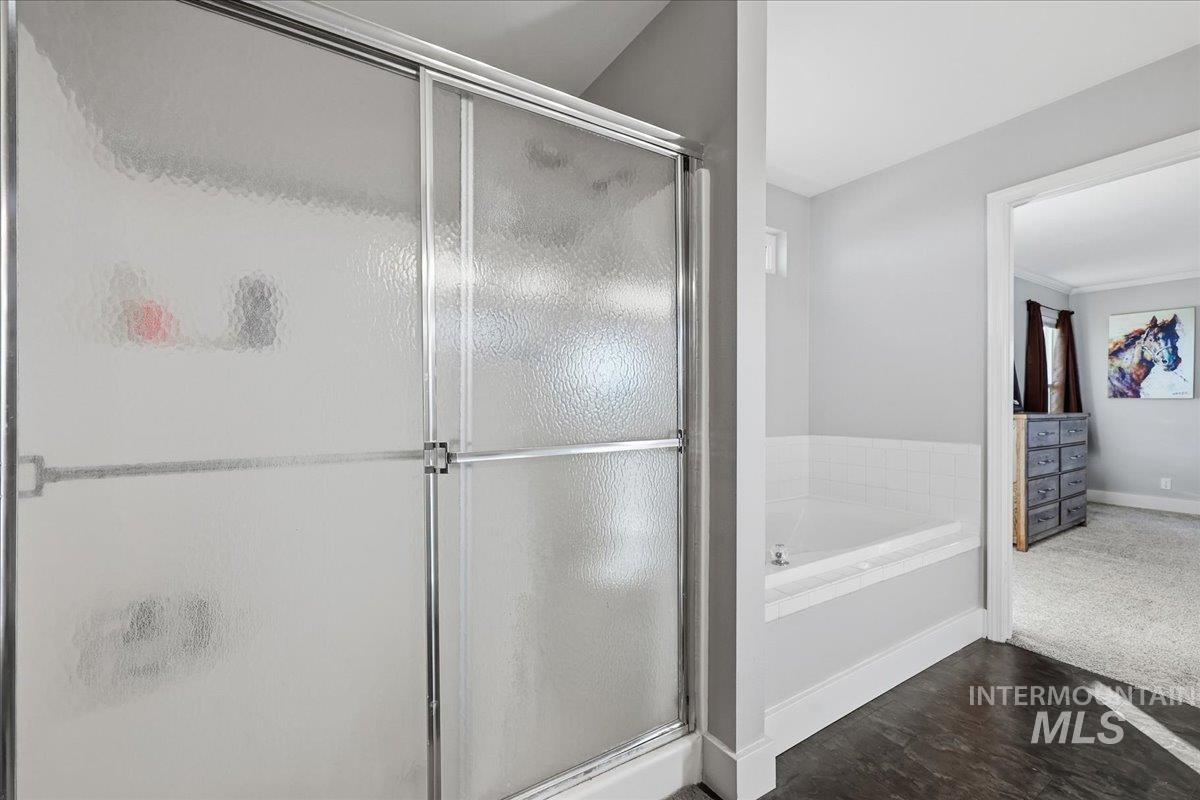 3293 West Twin View Lane Meridian, ID 83642 - Photo 18 of 43 Full bathroom featuring a shower stall, a bath, and dark wood-style floors