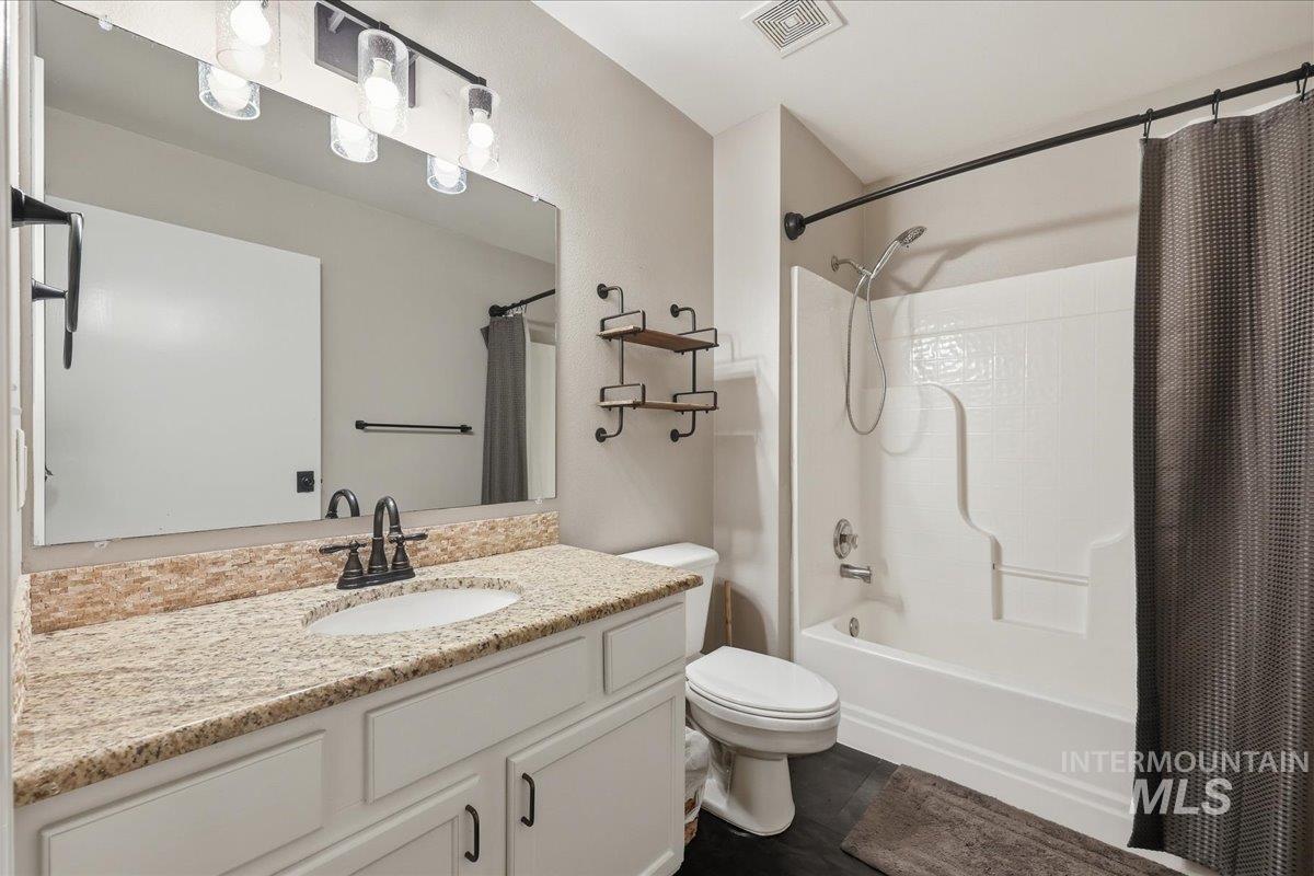 3293 West Twin View Lane Meridian, ID 83642 - Photo 28 of 43 Bathroom featuring shower / bathtub combination with curtain and vanity