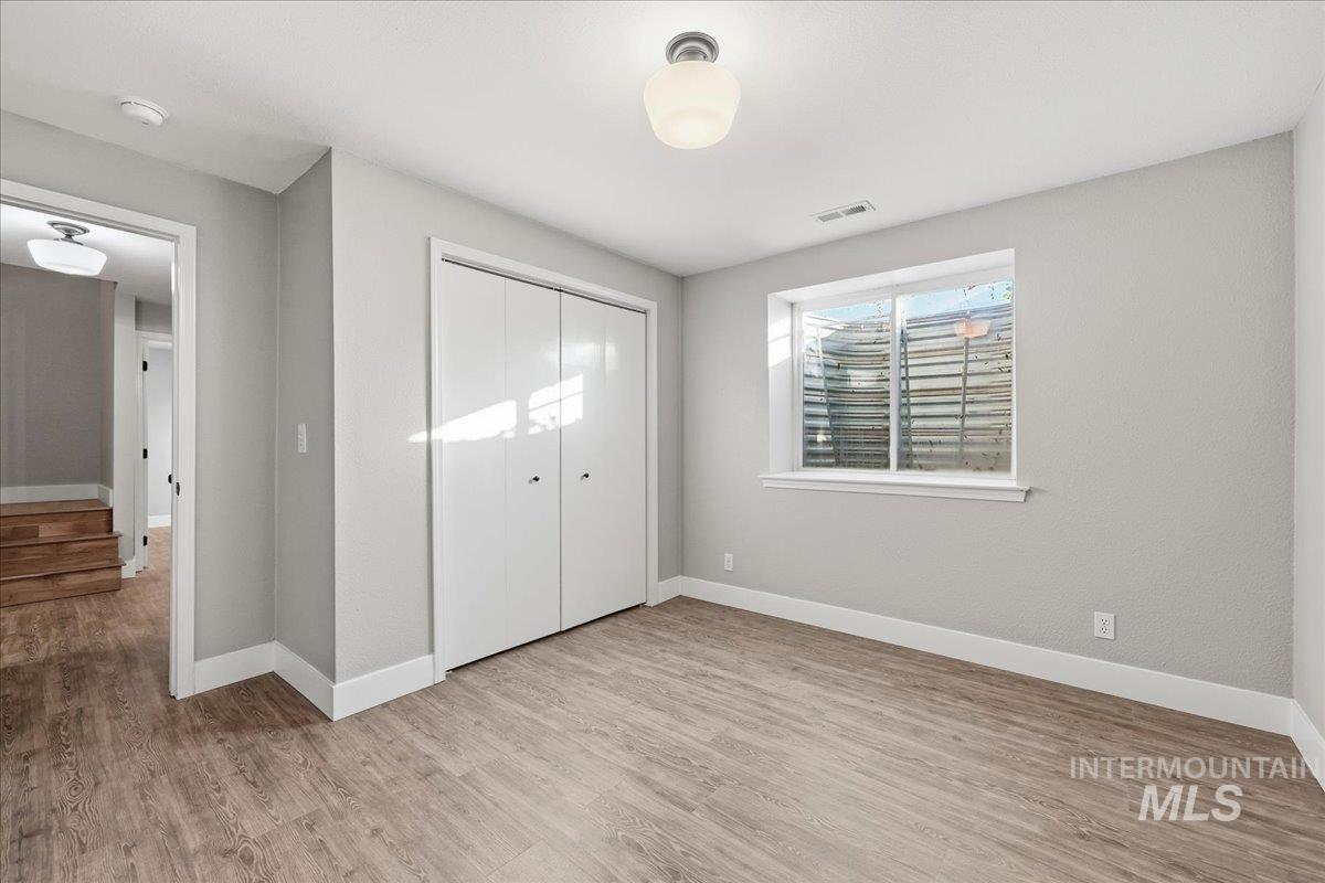 3293 West Twin View Lane Meridian, ID 83642 - Photo 34 of 43 Unfurnished bedroom featuring light wood finished floors and a closet