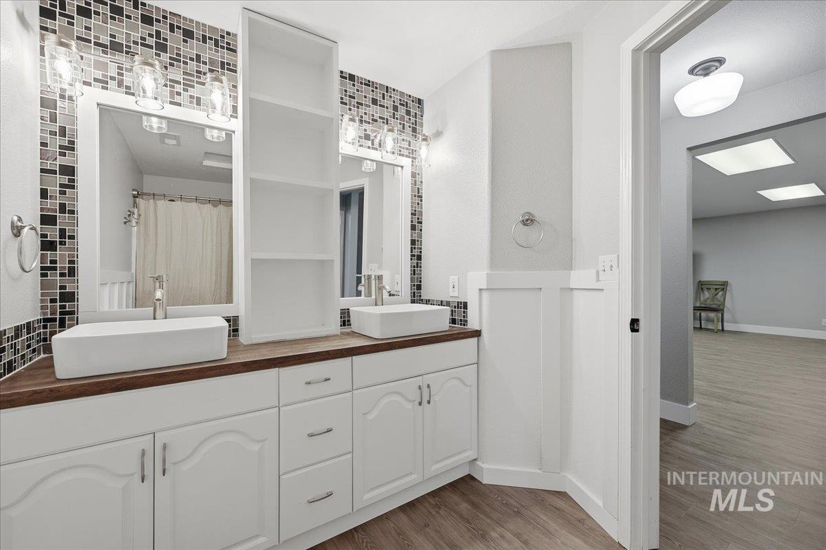 3293 West Twin View Lane Meridian, ID 83642 - Photo 36 of 43 Full bath with double vanity, wood finished floors, and a shower with curtain