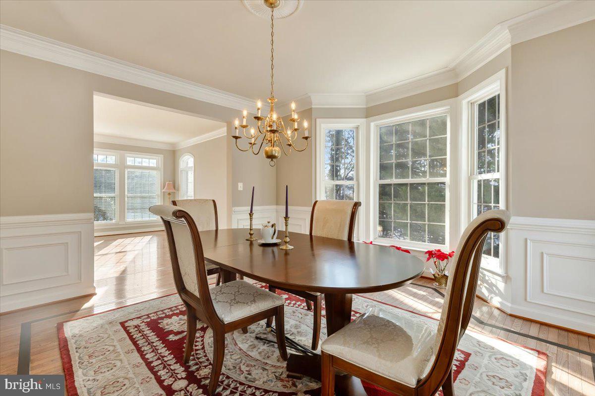 13714 Monet Court Chantilly, VA 20151 - Photo 14 of 58 a view of a dining room with furniture and a chandelier