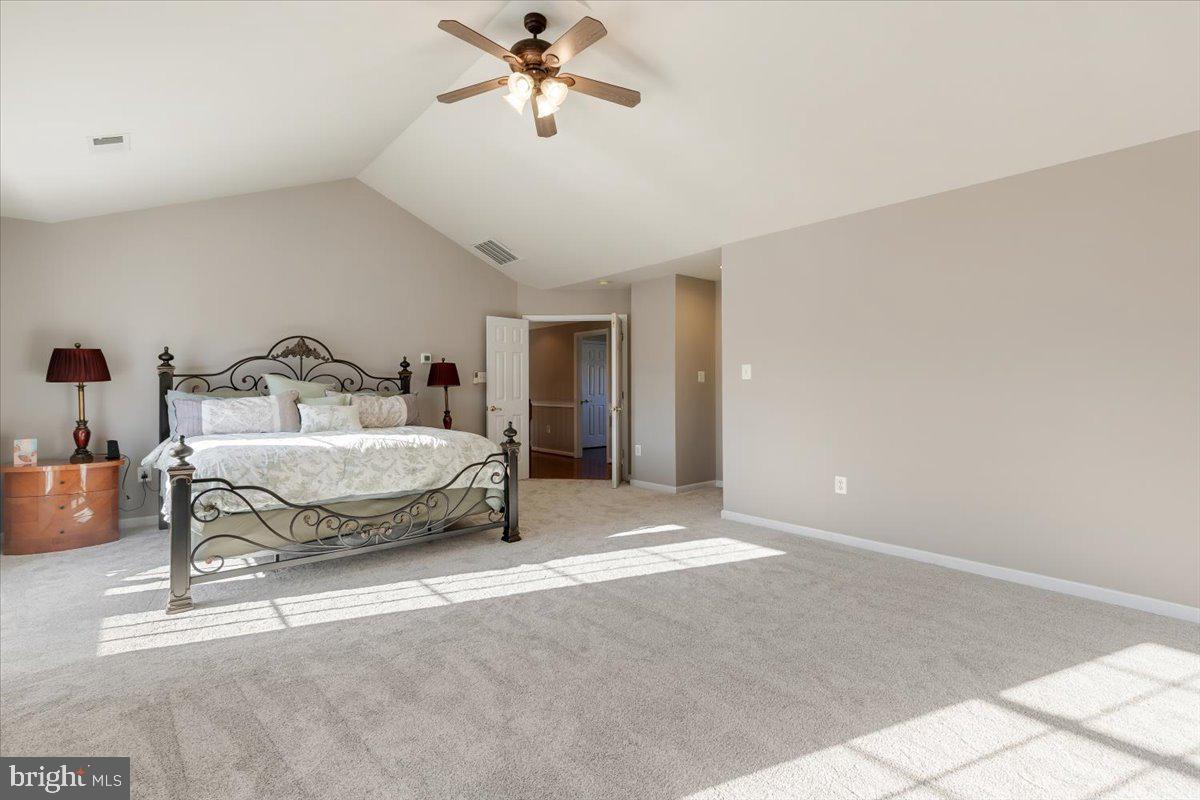 13714 Monet Court Chantilly, VA 20151 - Photo 30 of 58 a bedroom with a bed and a chandelier