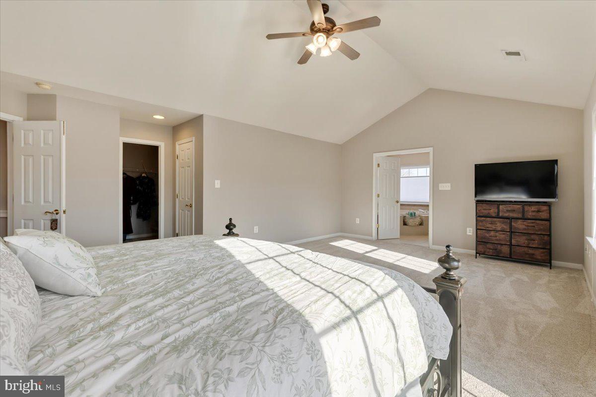 13714 Monet Court Chantilly, VA 20151 - Photo 32 of 58 a bedroom with a bed and a flat screen tv