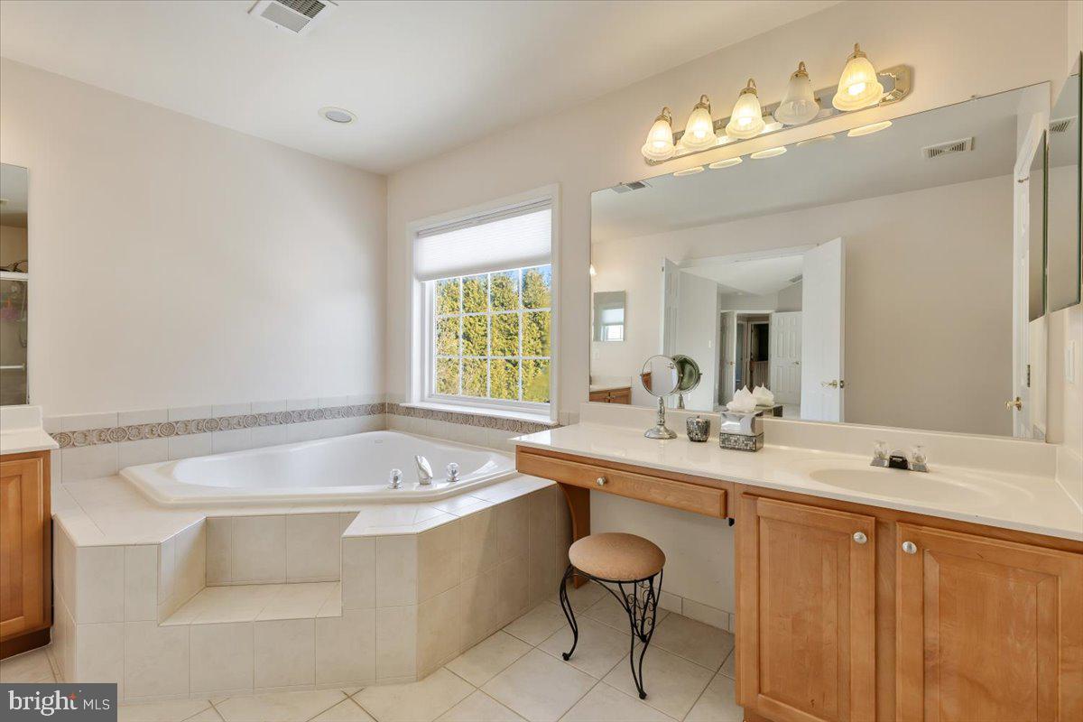 13714 Monet Court Chantilly, VA 20151 - Photo 33 of 58 a bathroom with a tub sink and mirror