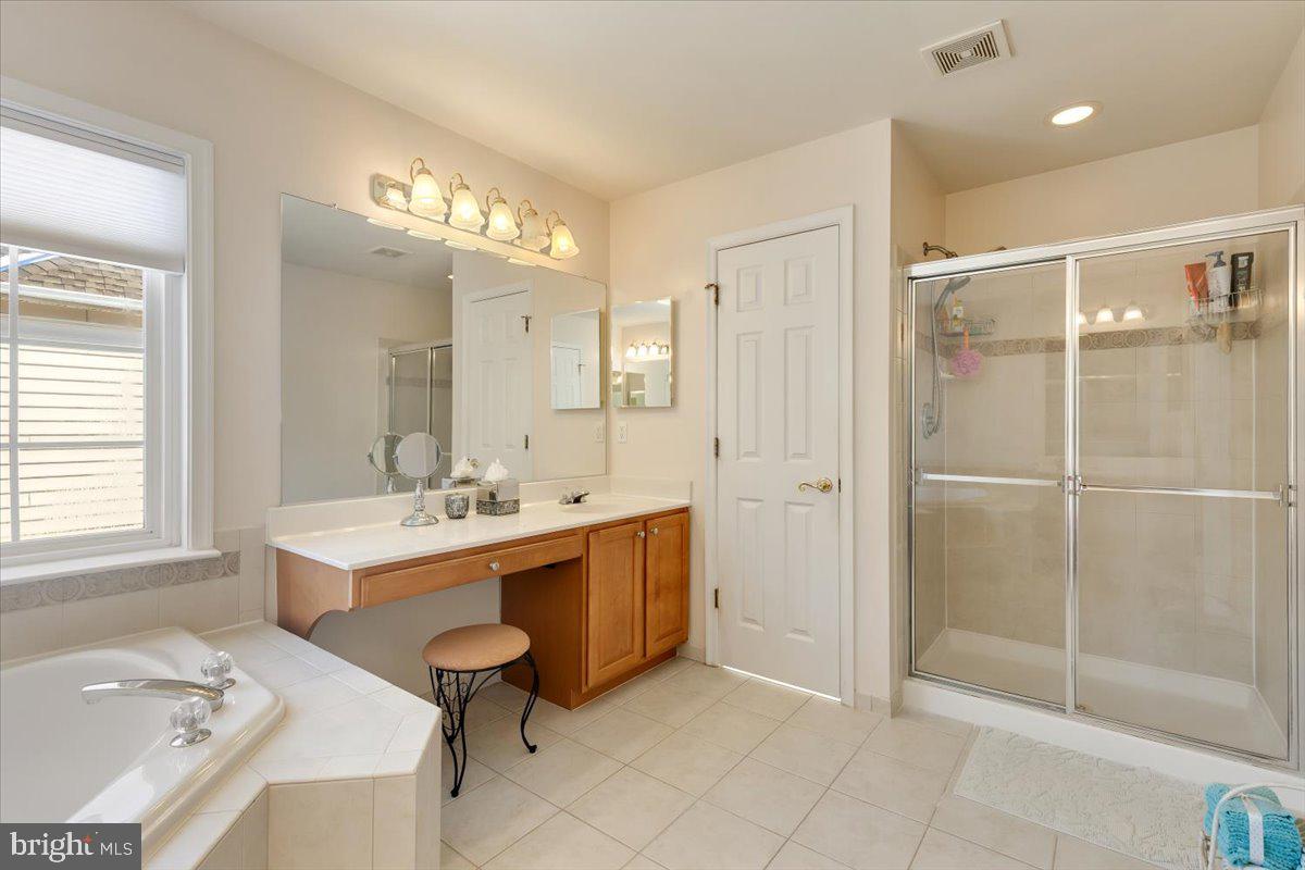 13714 Monet Court Chantilly, VA 20151 - Photo 34 of 58 a bathroom with a sink tub shower and a mirror