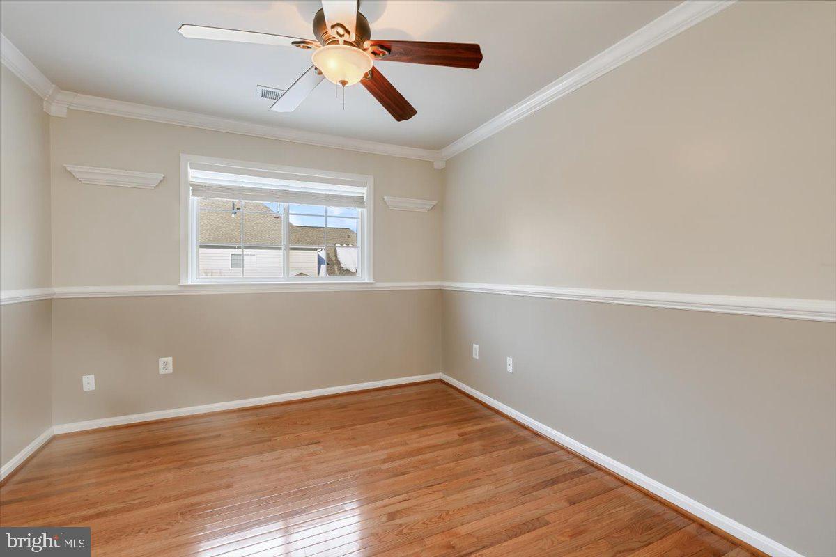 13714 Monet Court Chantilly, VA 20151 - Photo 37 of 58 an empty room with wooden floor a ceiling fan and windows