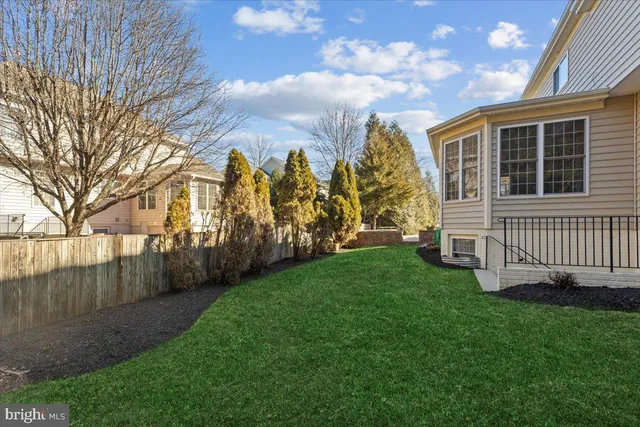 a view of a house with a yard and pathway