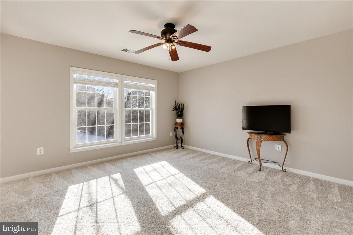 13714 Monet Court Chantilly, VA 20151 - Photo 42 of 58 a living room with a flat screen tv and a large window