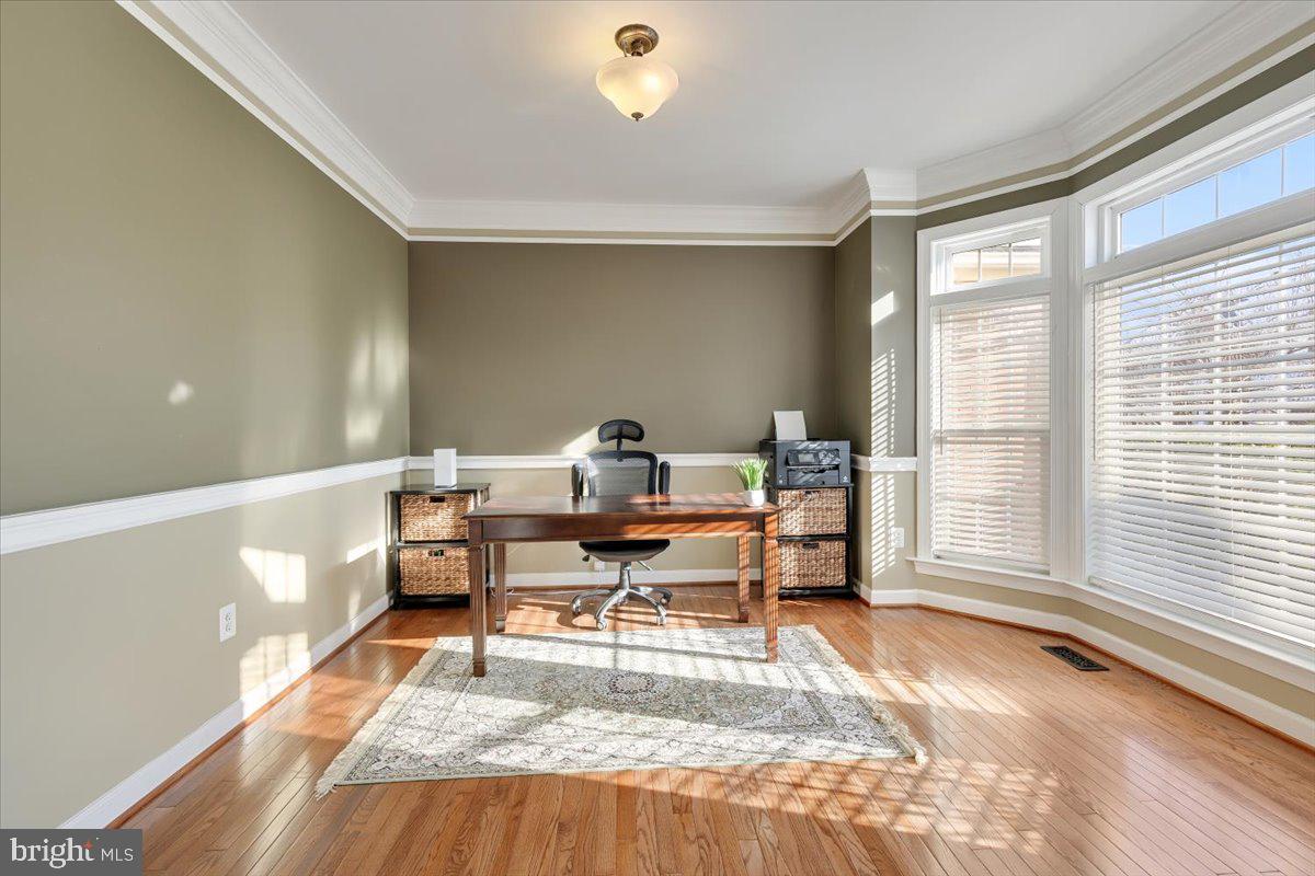 13714 Monet Court Chantilly, VA 20151 - Photo 8 of 58 a living room with furniture a wooden floor and a large window