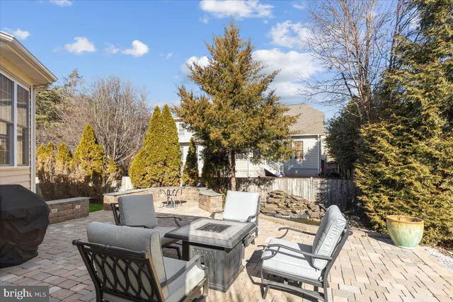 a view of a patio with couches table and chairs and potted plants