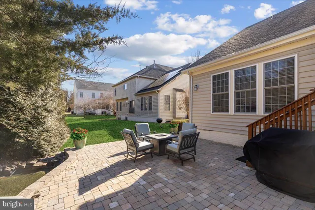 a view of a house with backyard sitting area and garden