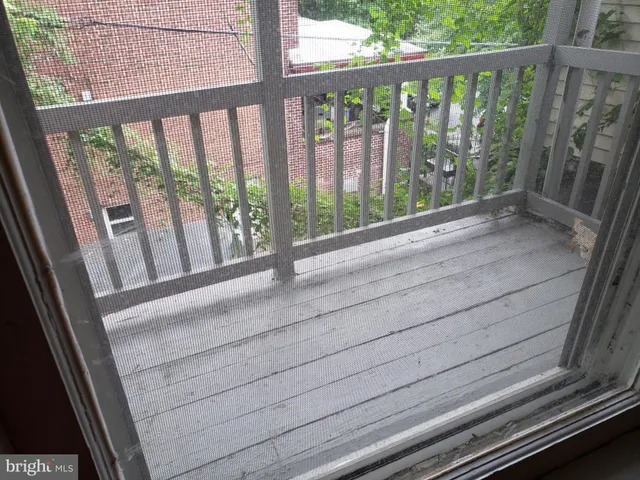 a view of a balcony with wooden floor