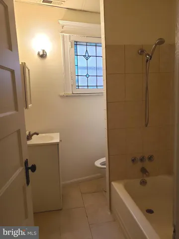 a bathroom with a bathtub and toilet