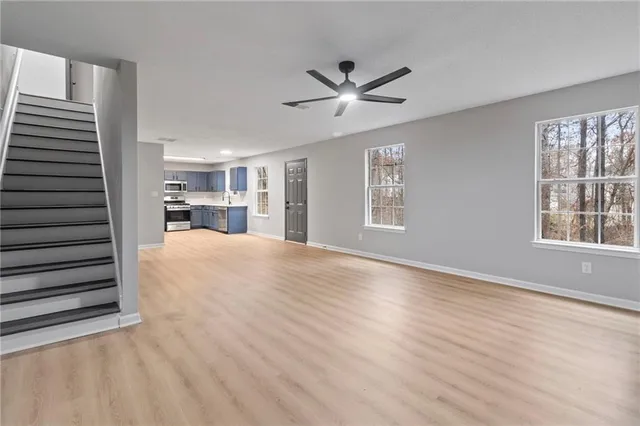 a view of a livingroom with a ceiling fan and window