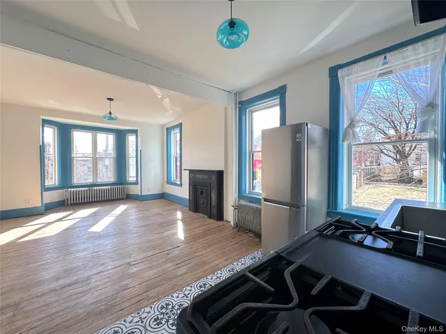 a kitchen with a refrigerator and a stove top oven