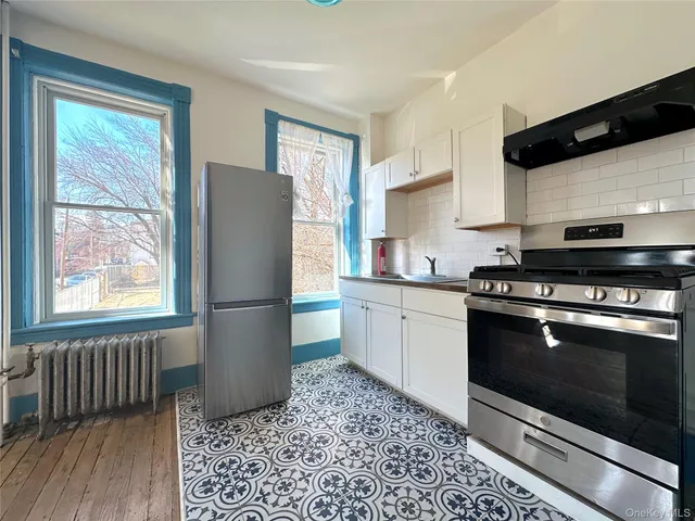 a kitchen with a refrigerator stove and wooden cabinets
