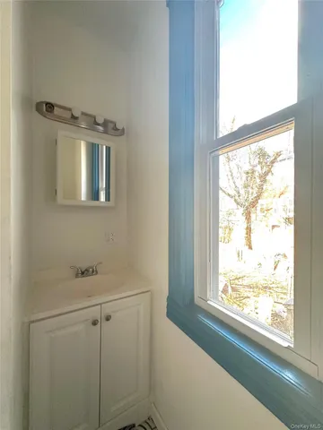 a bathroom with a window sink and vanity