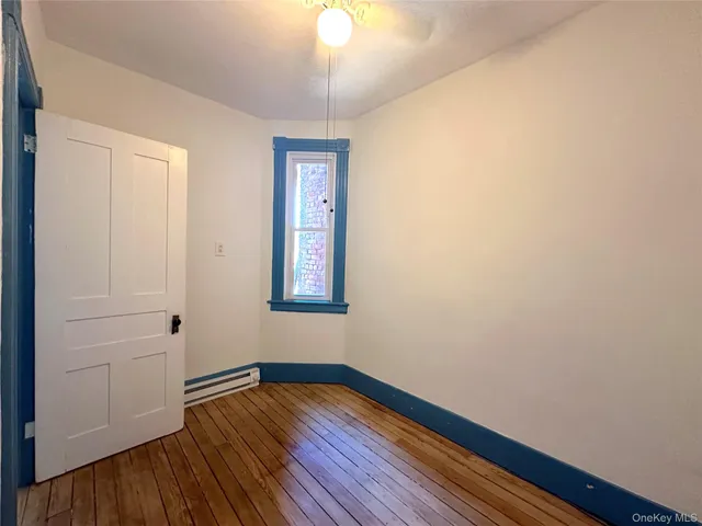wooden floor in an empty room with a window