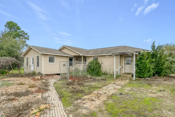 a view of an empty room with window and chandelier fan