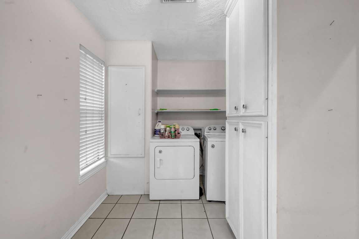 7644 Spring Cypress Road Spring, TX 77379 - Photo 15 of 28 a utility room with dryer and washer
