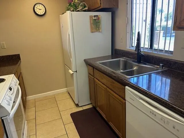 a kitchen with a sink a refrigerator and window