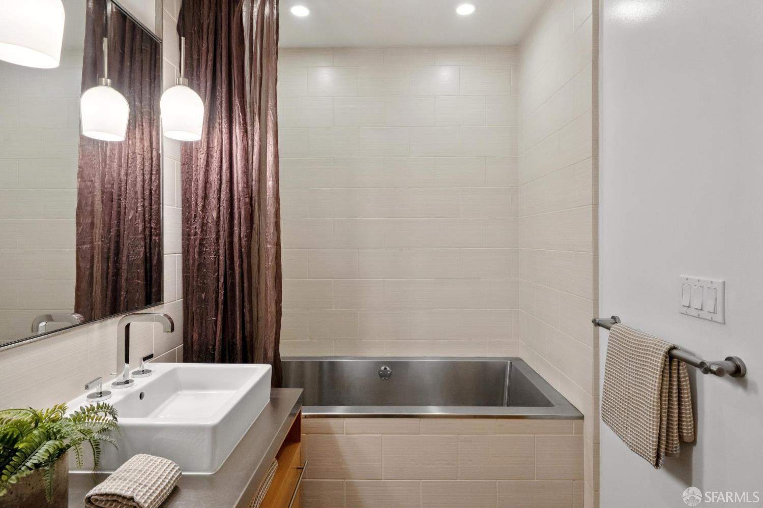 2 Mint Plaza, Unit 201 San Francisco, CA 94103 - Photo 21 of 40 a bathroom with a tub sink and mirror