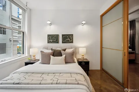 a bedroom with a bed and a curtain