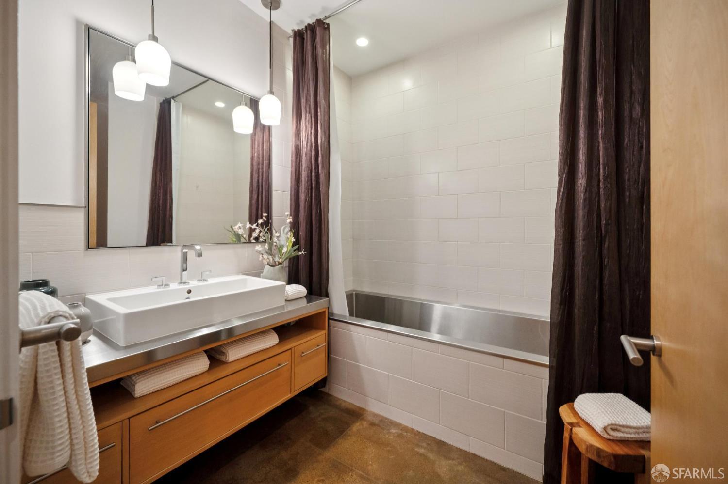 2 Mint Plaza, Unit 201 San Francisco, CA 94103 - Photo 29 of 40 a bathroom with a sink a toilet a mirror and shower